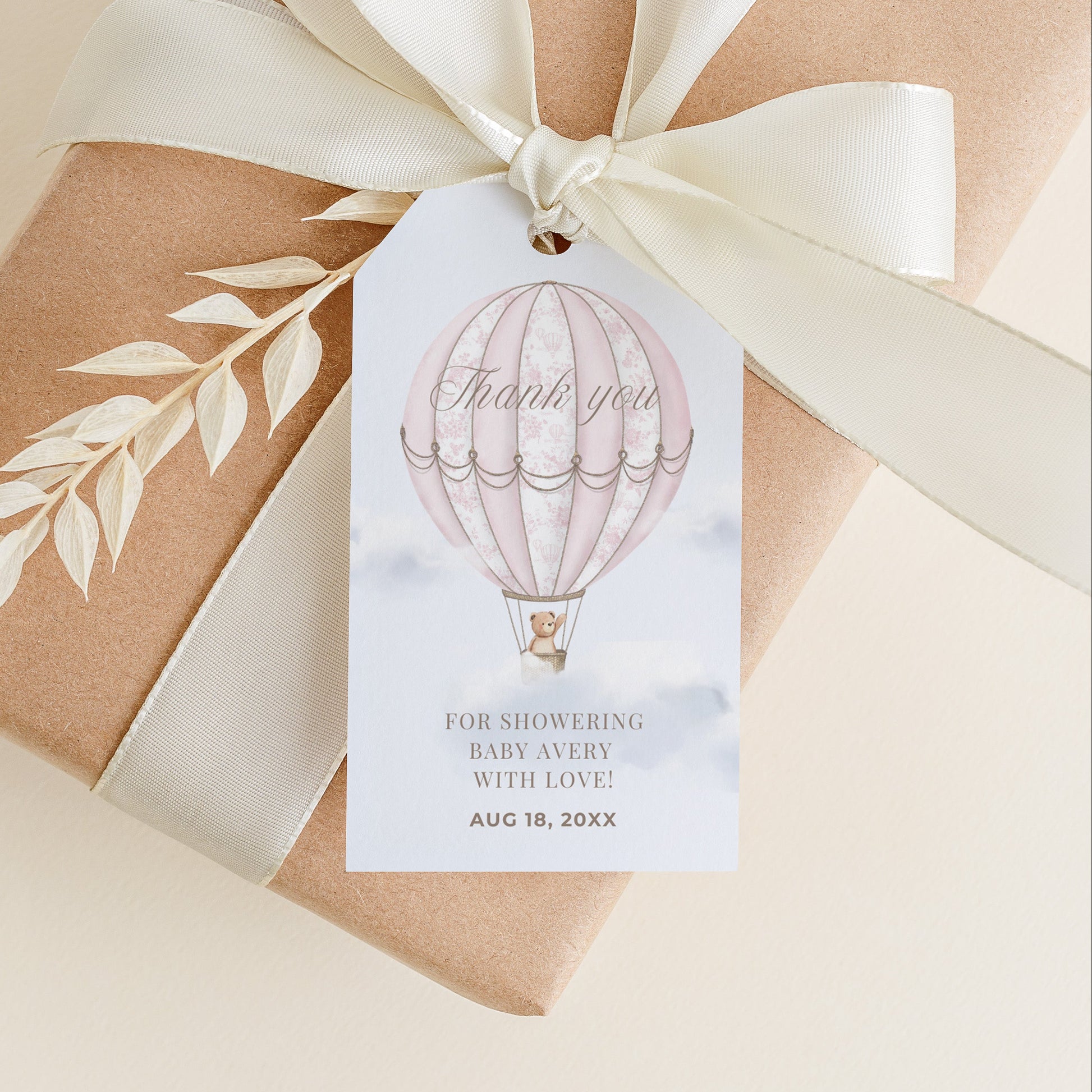Gift box wrapped in brown paper with a white ribbon and 'Thank you' tag on a beige background