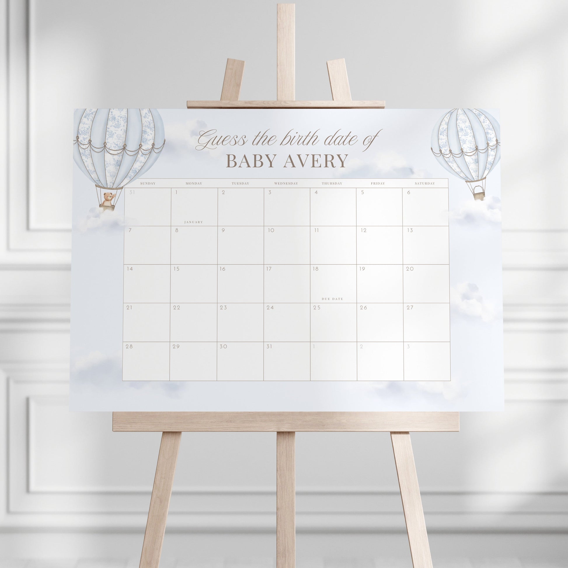 Due Date Calendar with baby milestone tracker on an easel stand against a white wall