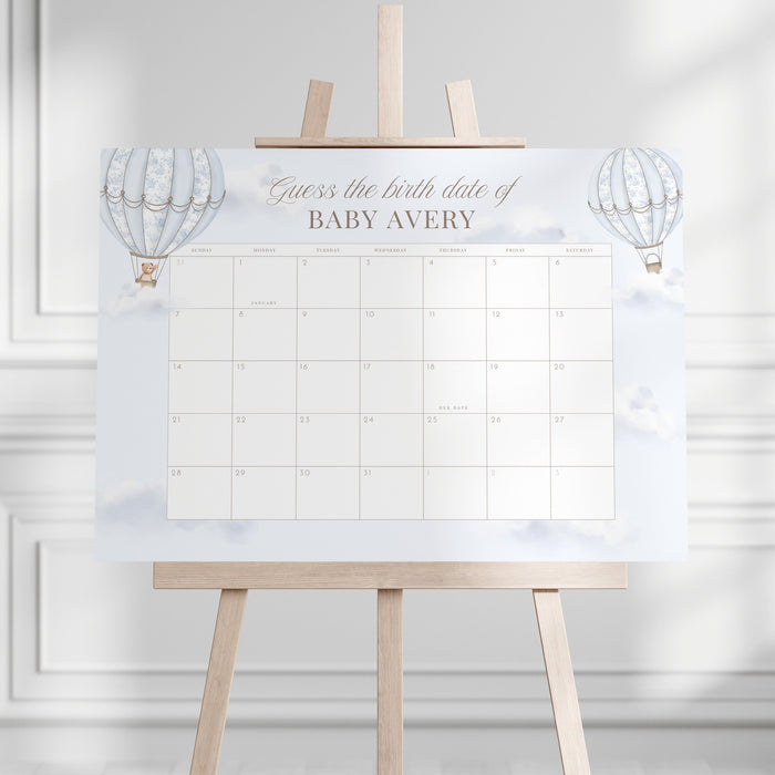 Due Date Calendar with baby milestone tracker on an easel stand against a white wall