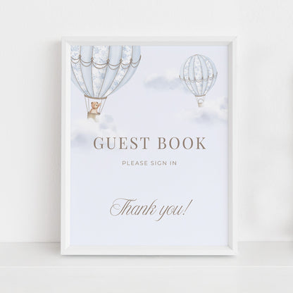 Table Sign with hot air balloons in a white frame sitting against a light background