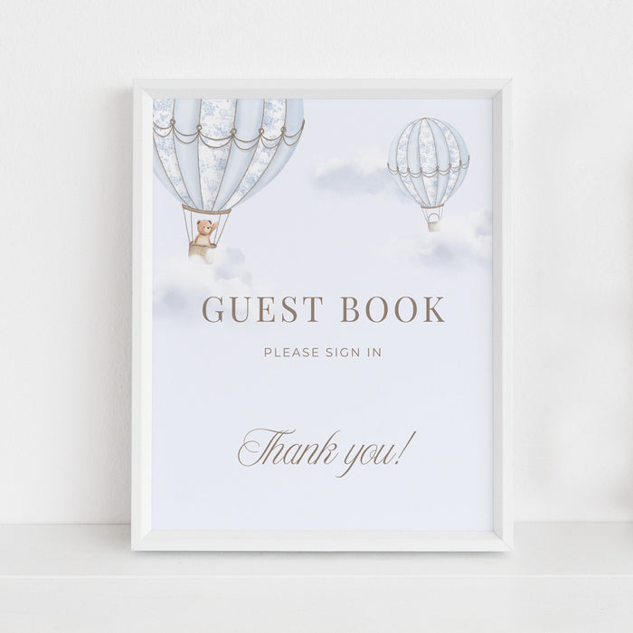 Table Sign with hot air balloons in a white frame sitting against a light background