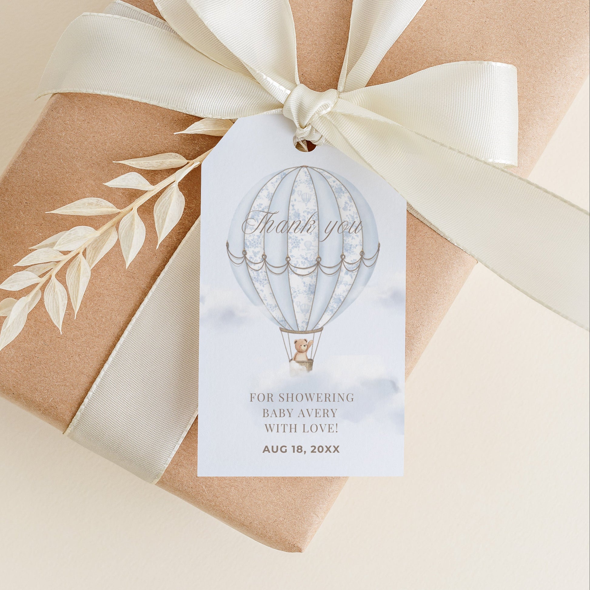 Gift box wrapped in brown paper with a white ribbon and 'Thank you' tag on a beige background