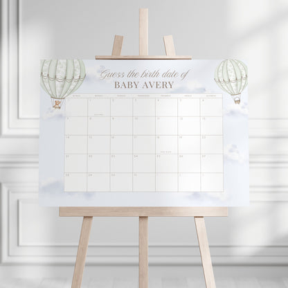 Guess the Birth Date Calendar on an easel against a white wall.