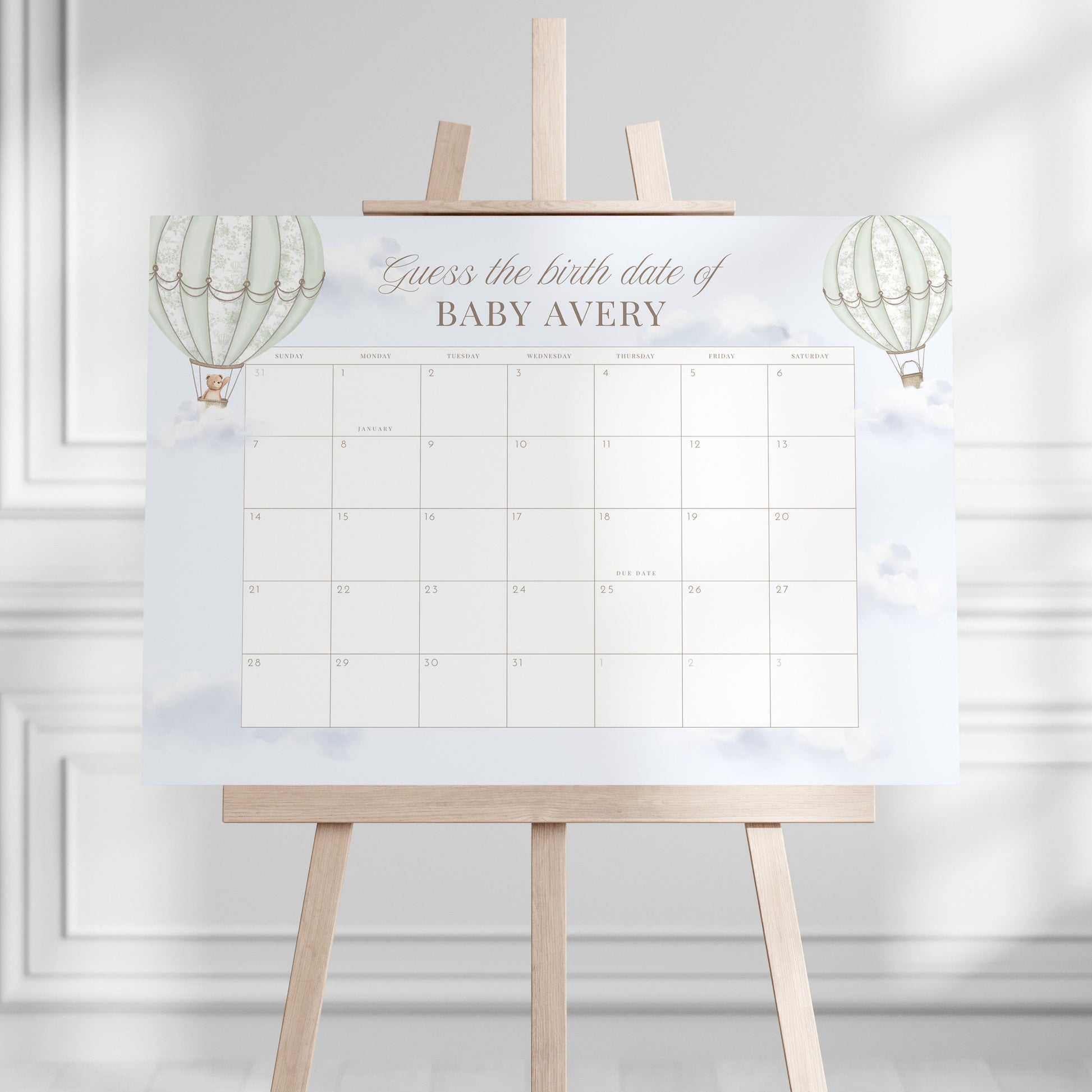 Due Date Calendar with baby milestone markers on a stand against a white wall.