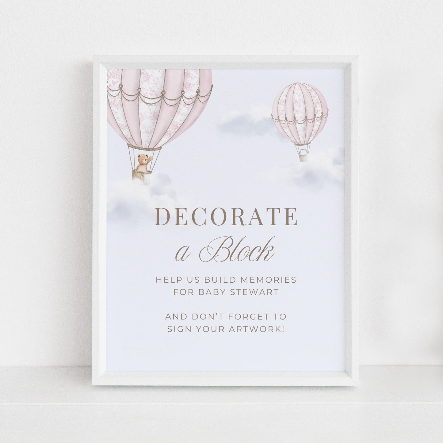 Framed Table Sign with hot air balloons and baby shower invitation text on a light background