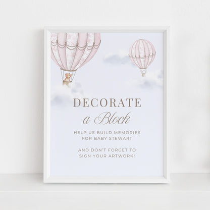 Framed Table Sign with hot air balloons and baby shower invitation text on a light background