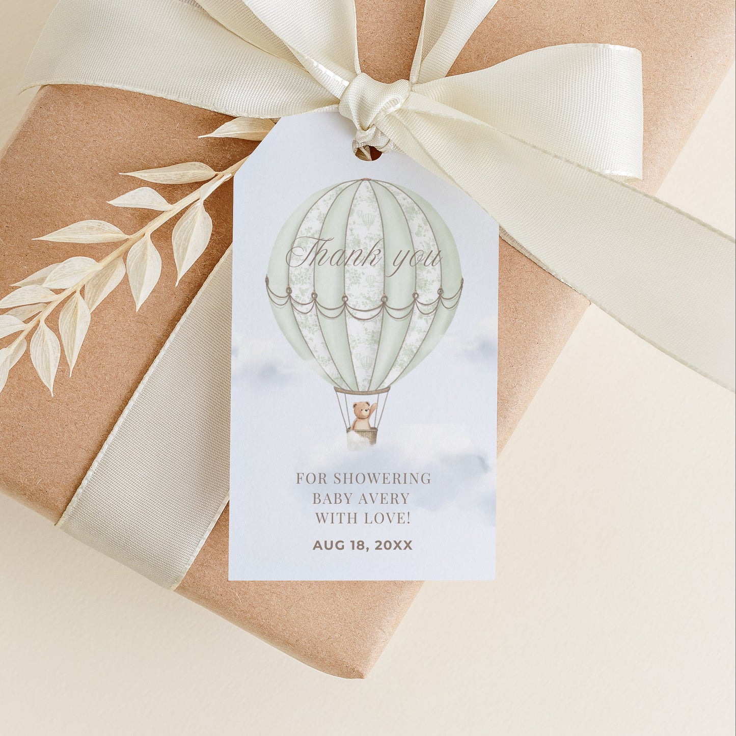 Gift box wrapped in brown paper with a white ribbon and 'Thank you' tag on a beige background