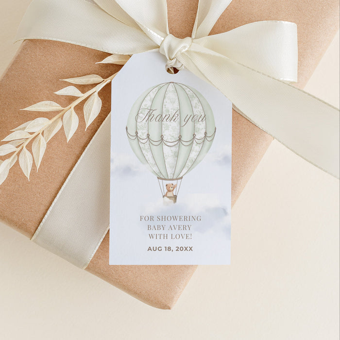 Gift box wrapped in brown paper with a white ribbon and 'Thank you' tag on a beige background