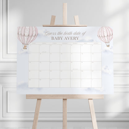 Guess the birth date calendar on an easel against a white wall
