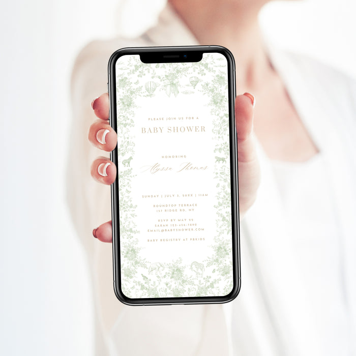 Person holding a smartphone with a baby shower invitation on the screen