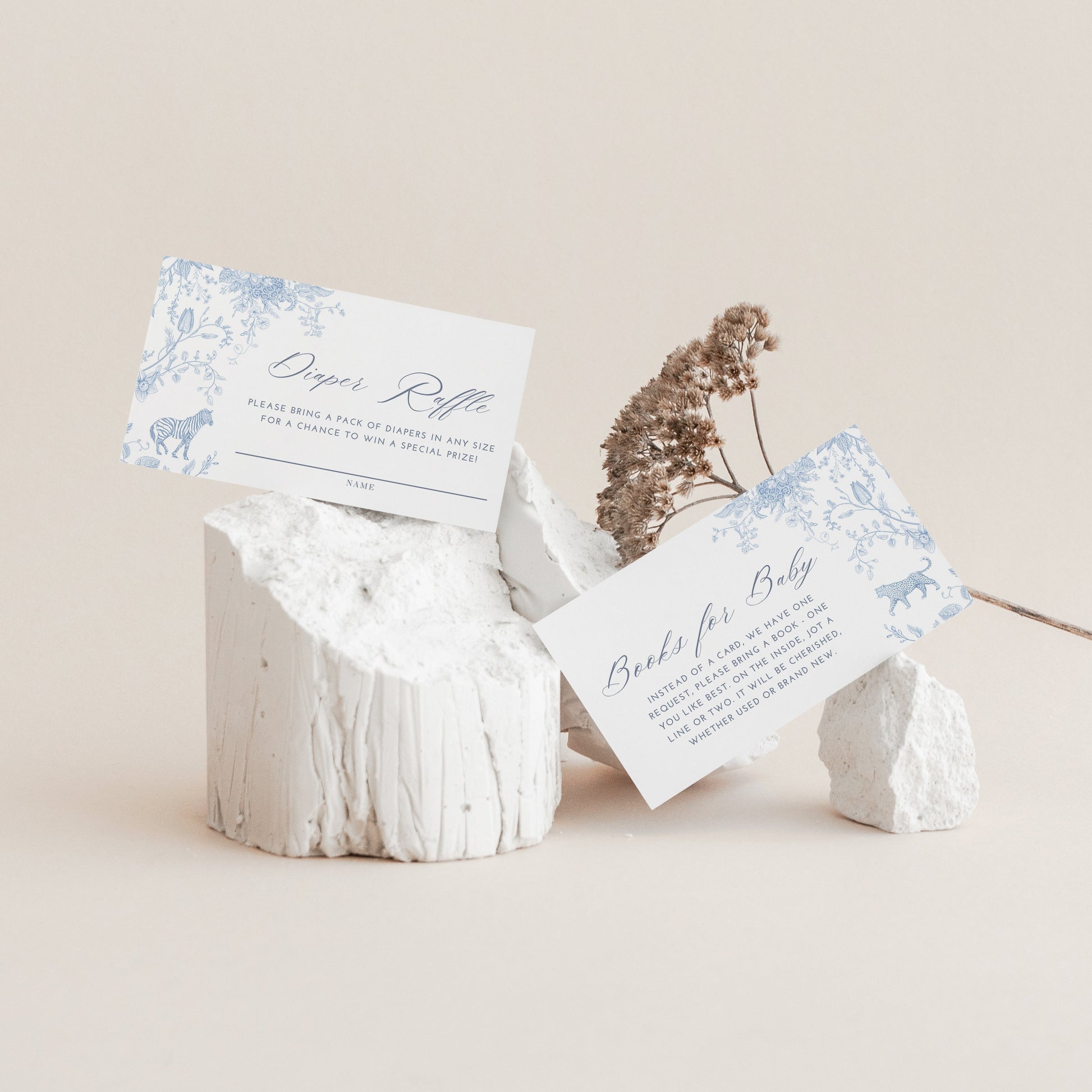 White stone holder with baby Diaper Raflle Card and Books for Baby Card on a beige background