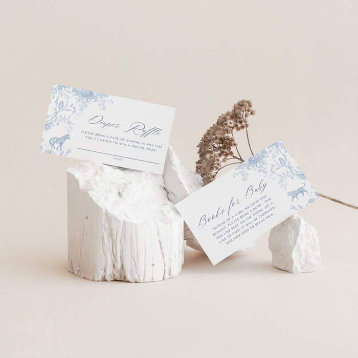 White stone holder with baby Diaper Raflle Card and Books for Baby Card on a beige background