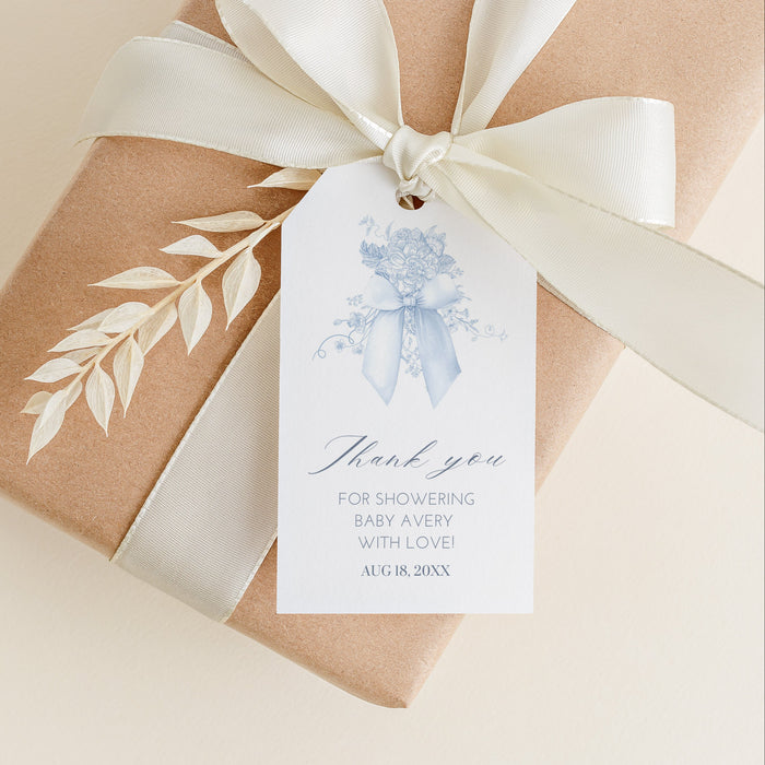 Gift box wrapped in brown paper with a white ribbon and 'thank you' tag on a beige background