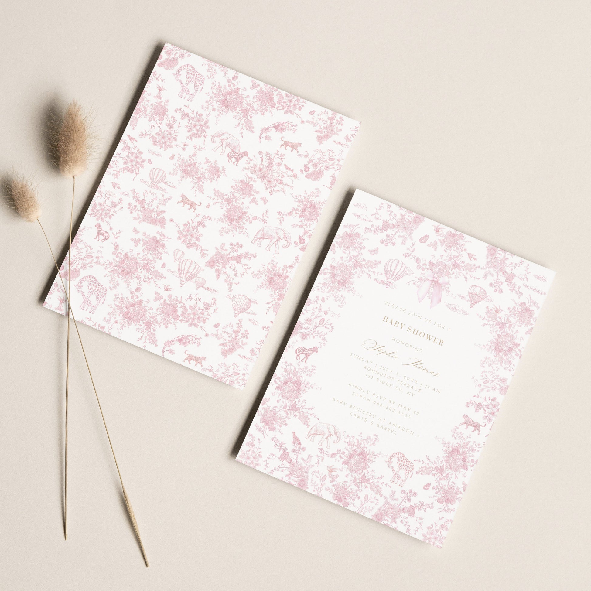Front and Back views of a Baby Shower Invitation with pink floral design on a beige surface with dried grasses.