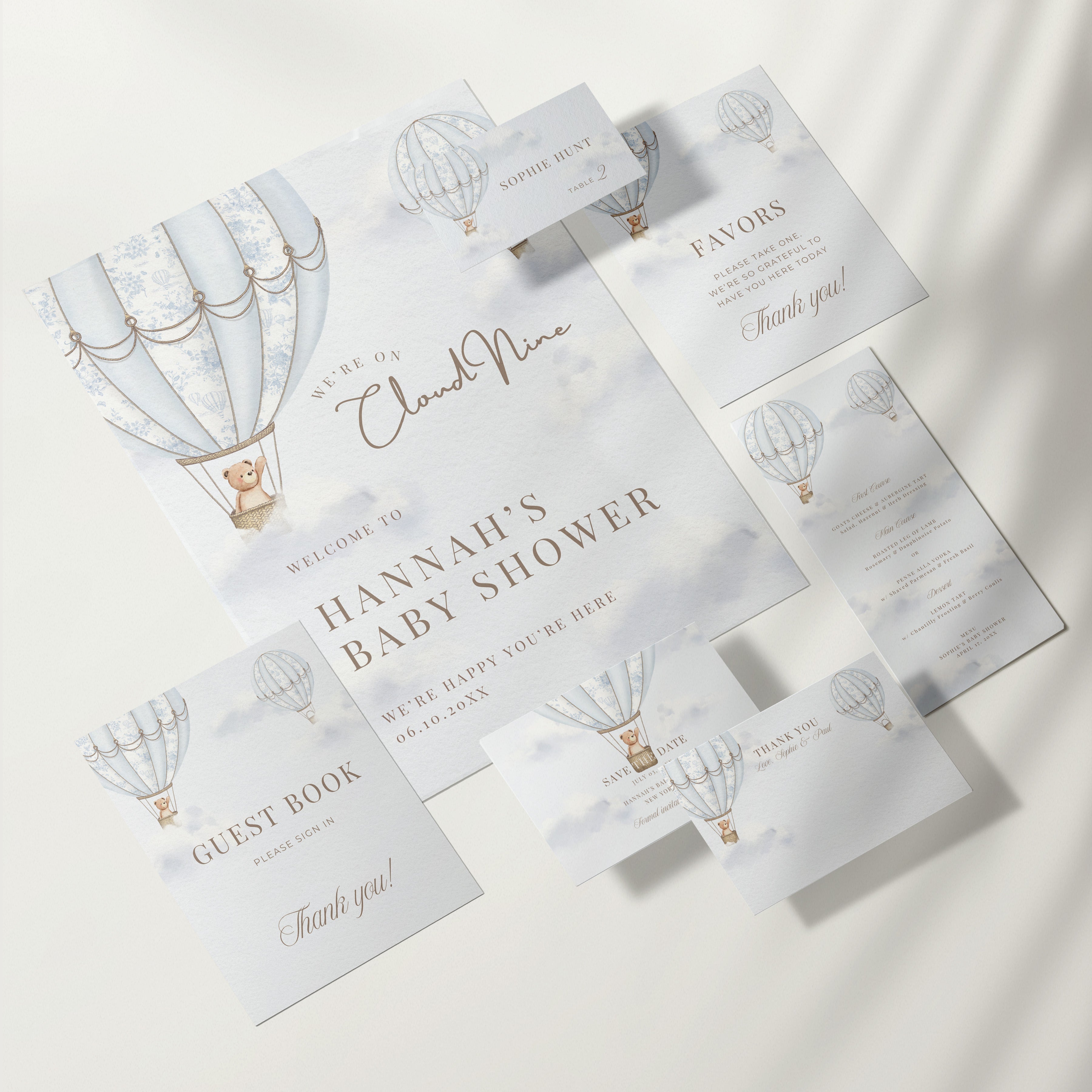 Baby shower invitation set with hot air balloon design on a white background