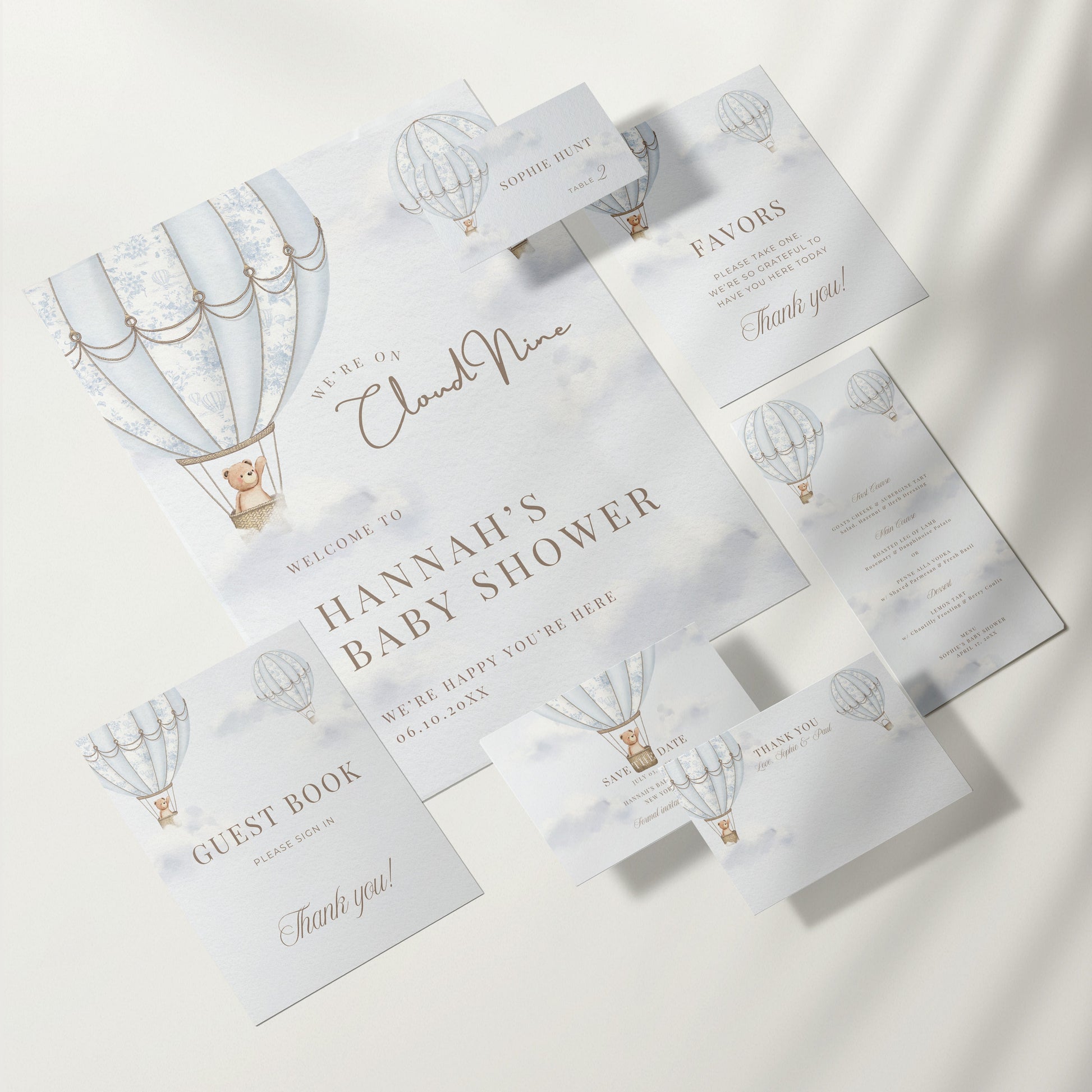 Baby shower invitation set with hot air balloon design on a white background