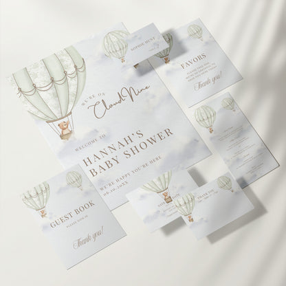 Collection of baby shower invitations with green hot air balloon design on a white background