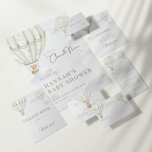 Collection of baby shower invitations with green hot air balloon design on a white background