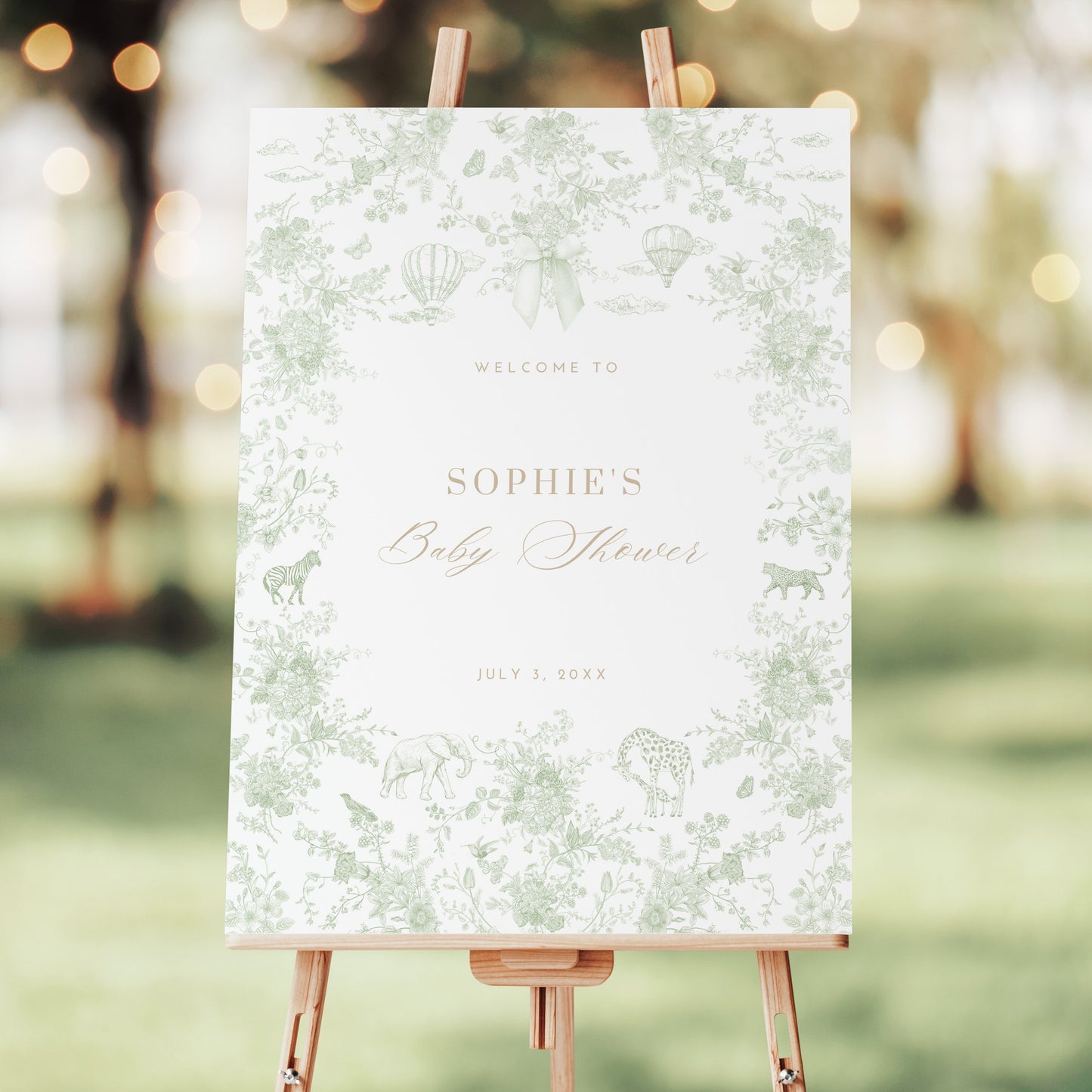 Baby shower welcome sign on an easel with a blurred outdoor background