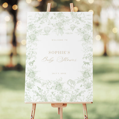 Baby shower welcome sign on an easel with a blurred outdoor background