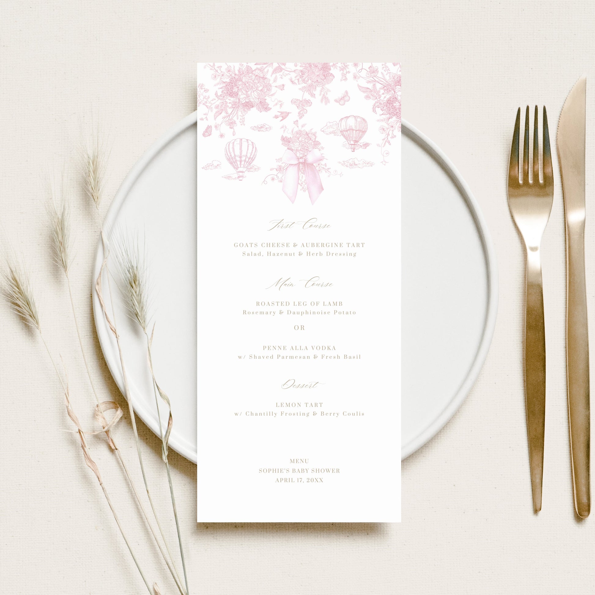 Place setting with a floral menu card on a white plate, accompanied by a fork and knife.