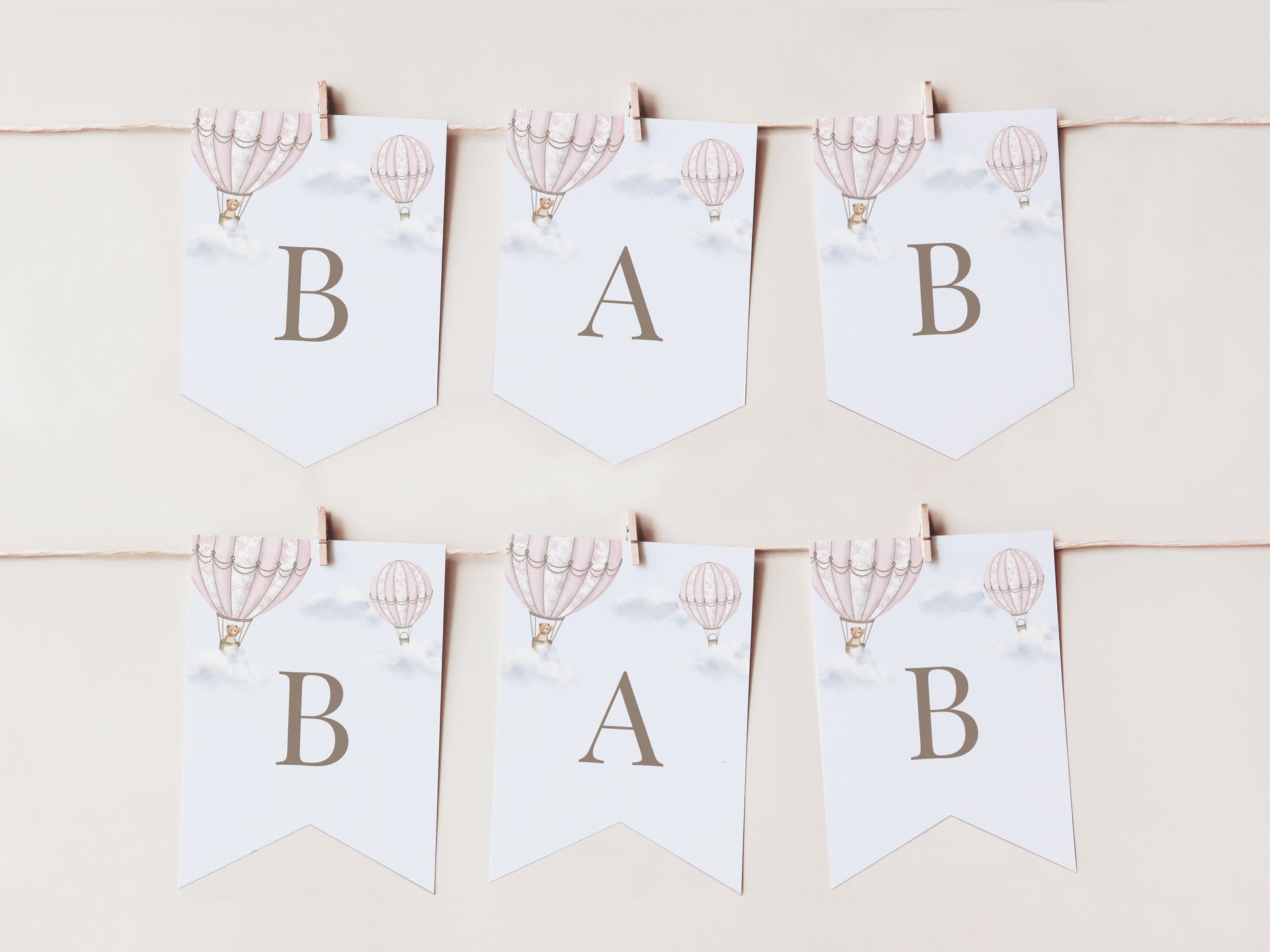 Baby shower banner with hot air balloons and letters 'B', 'A', 'B' on a light background