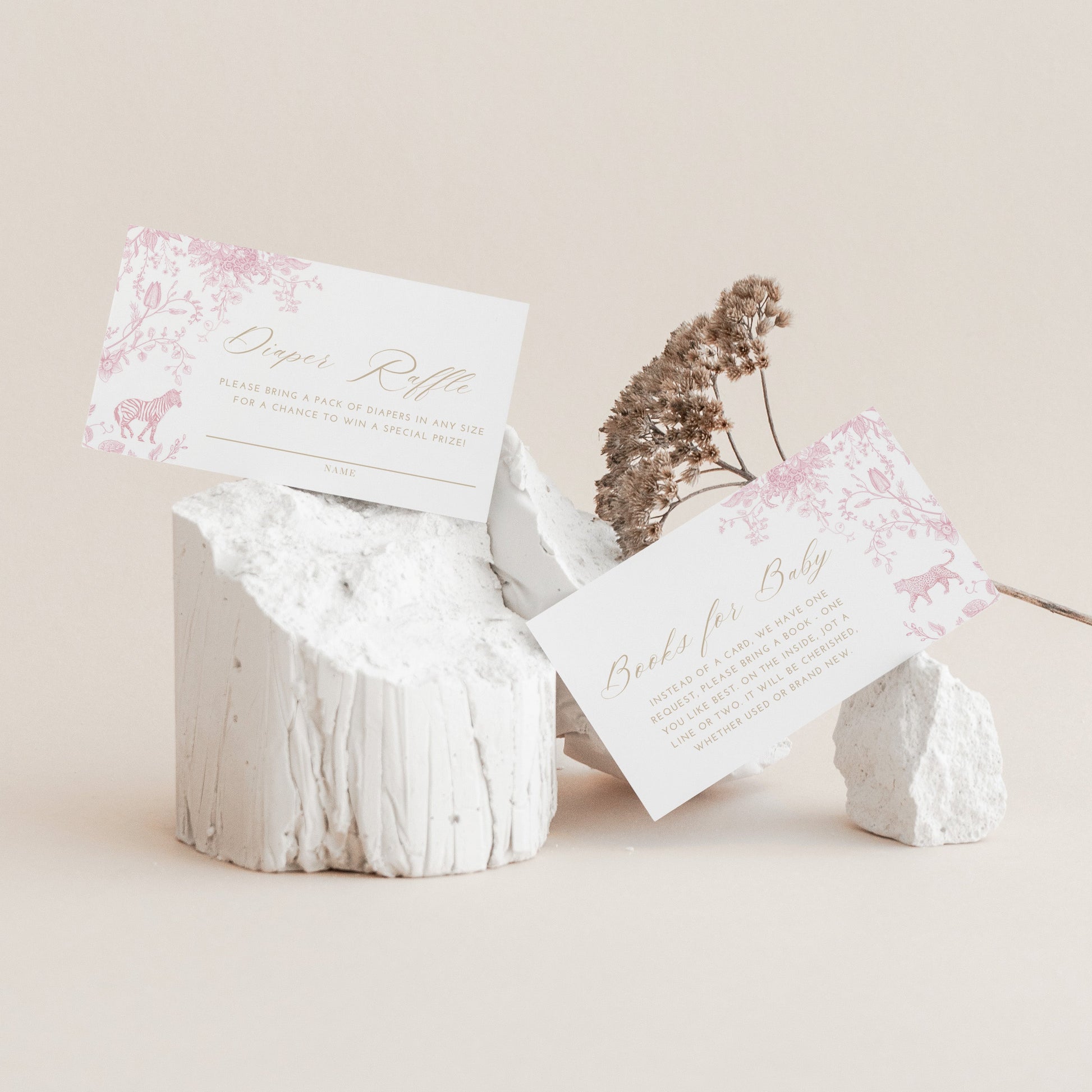 White stone-like boxes with floral designs and text on a beige background