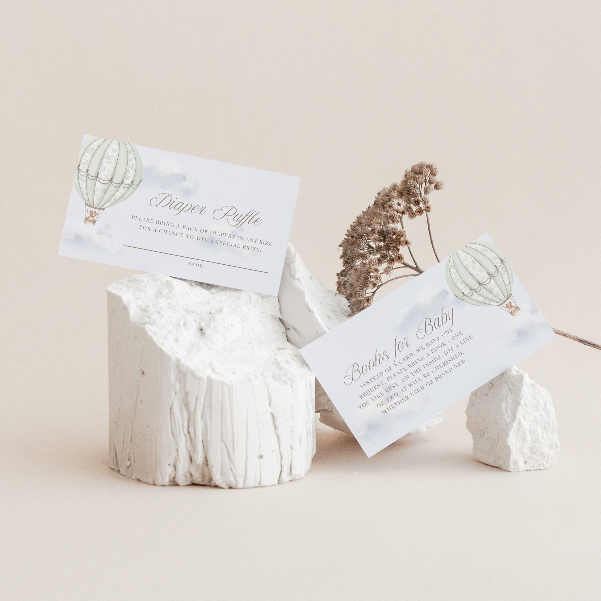 Decorative stone holder with Books for Baby and Diaper Raffle cards on a beige background