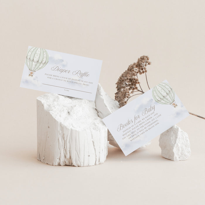 Decorative stone holder with Books for Baby and Diaper Raffle cards on a beige background